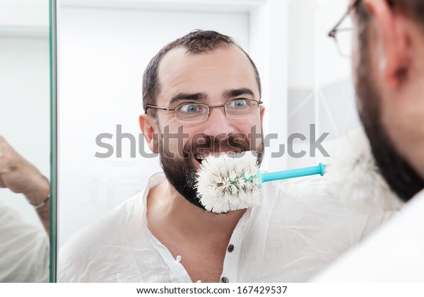 portrait-man-brushing-his-teeth-600w-167429537.jpg